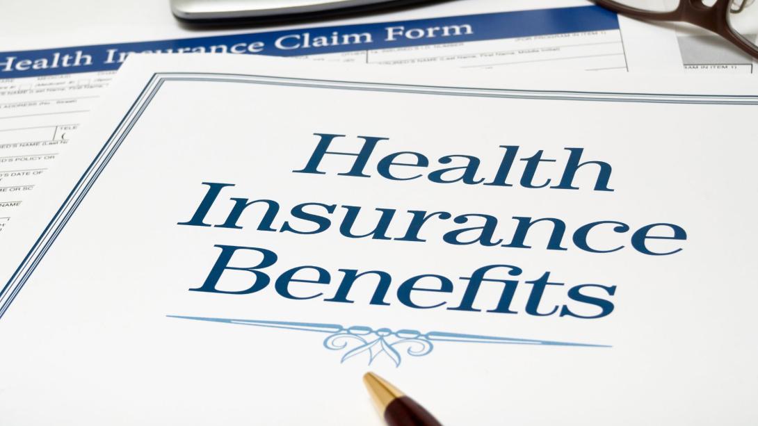 health insurance benefits form with pen and calculator