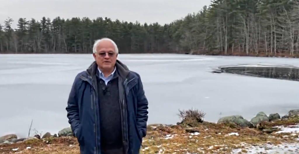 Chuck Grassie standing next to a frozen lake