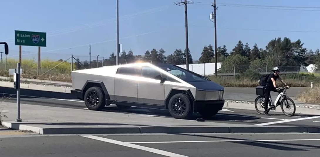 Tesla Cybertruck and a green vehicle