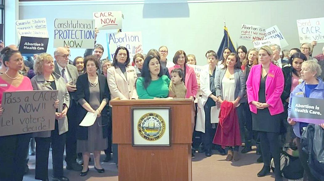 Rep. Amanda Toll speaks at a press conference