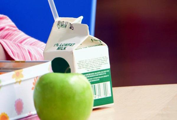 Milk carton and a green apple